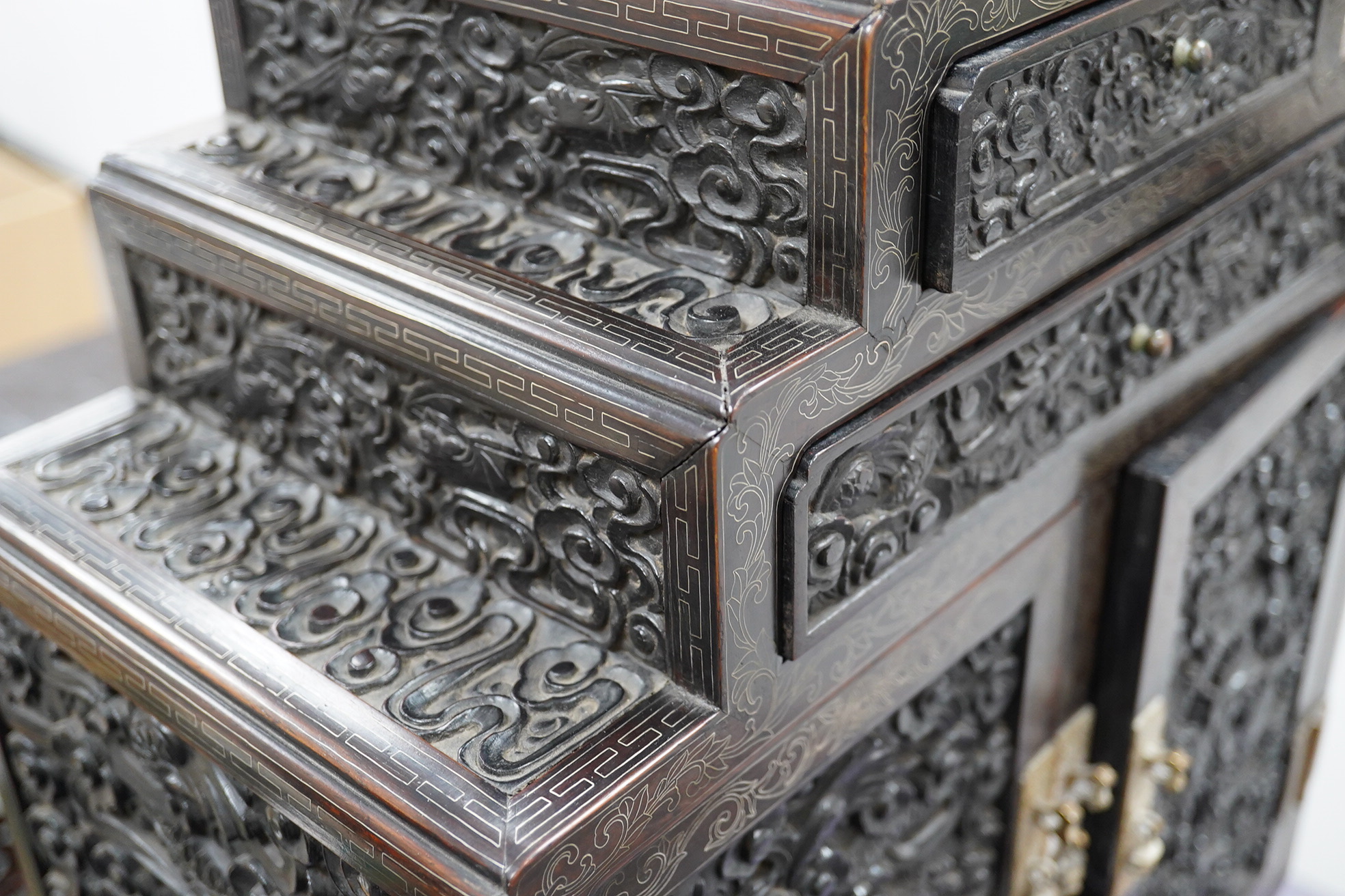 An important pair of Chinese carved zitan and silver wire inlaid ‘cloud and dragon’ curio cabinets and stands, duobaoge, probably Imperial, late Qing dynasty